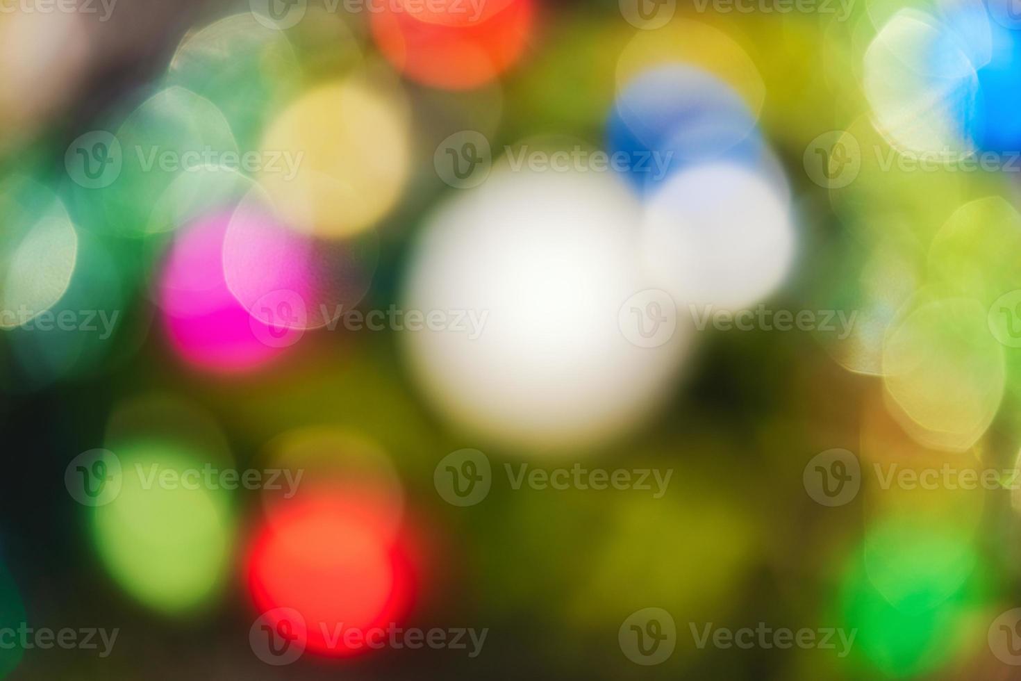 Defocused colorful Christmas holiday decorations, abstract blurry bokeh background effect. Out of focus glowing lights celebration texture for use at graphic design photo