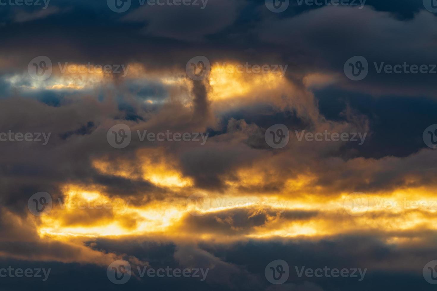 Beautiful dramatic clouds in sky illuminated by rays of sun at sunset to change weather. Colorful summer cloudscape abstract background photo