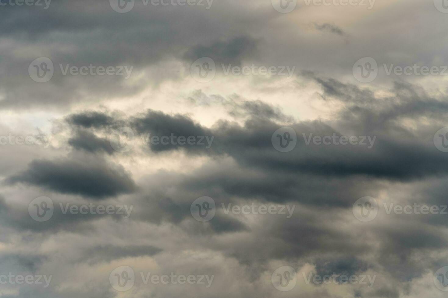 Dramatic thunderstorm clouds in dusk sky during rain. Amazing view of natural cloudiness weather background photo