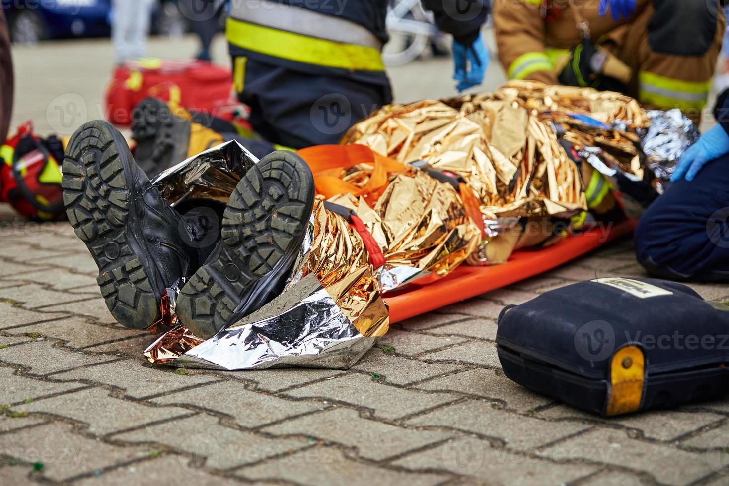 Rescuers provide first aid to the victim during car road accident photo