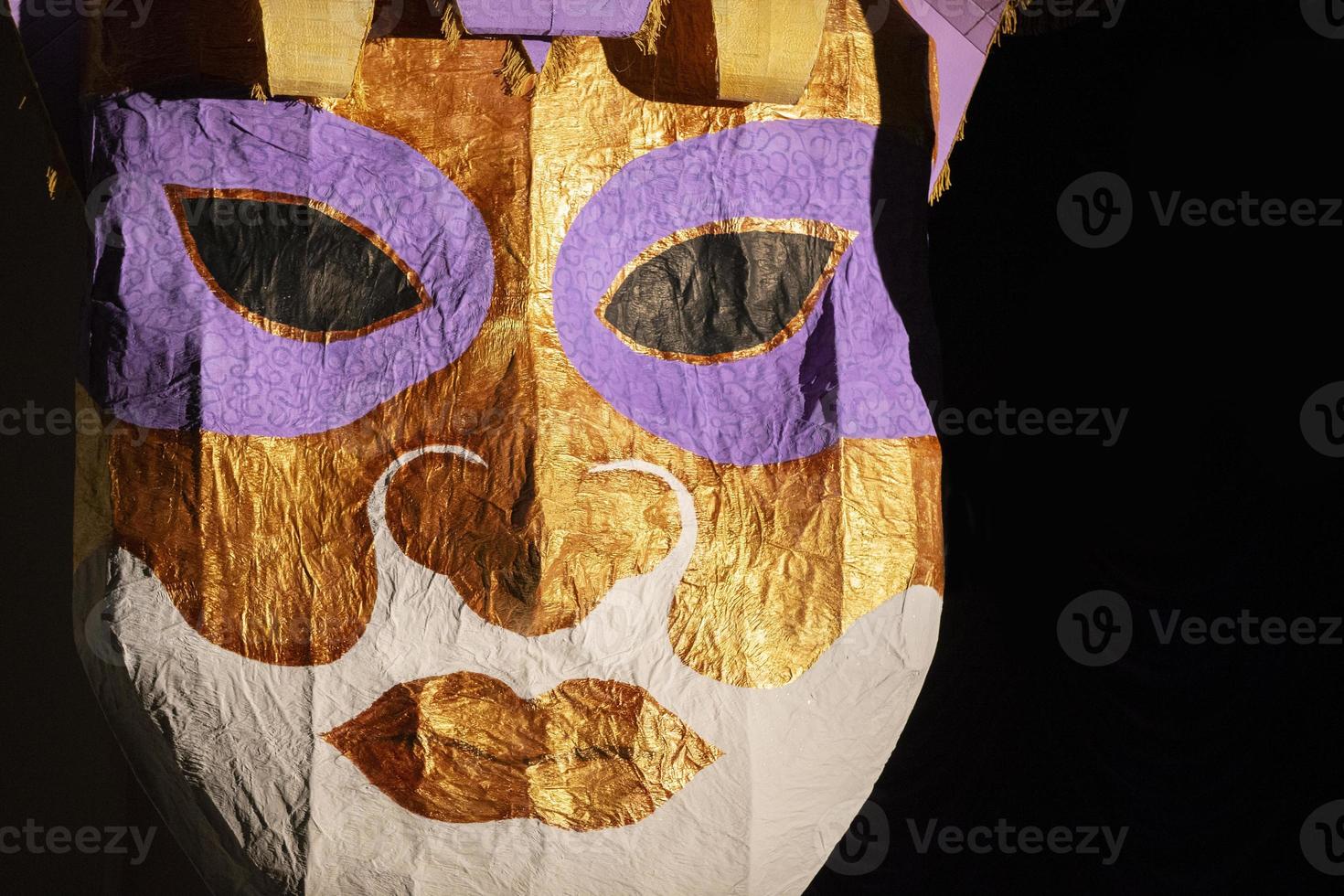 Large human face mask made of gold foil and papier photo