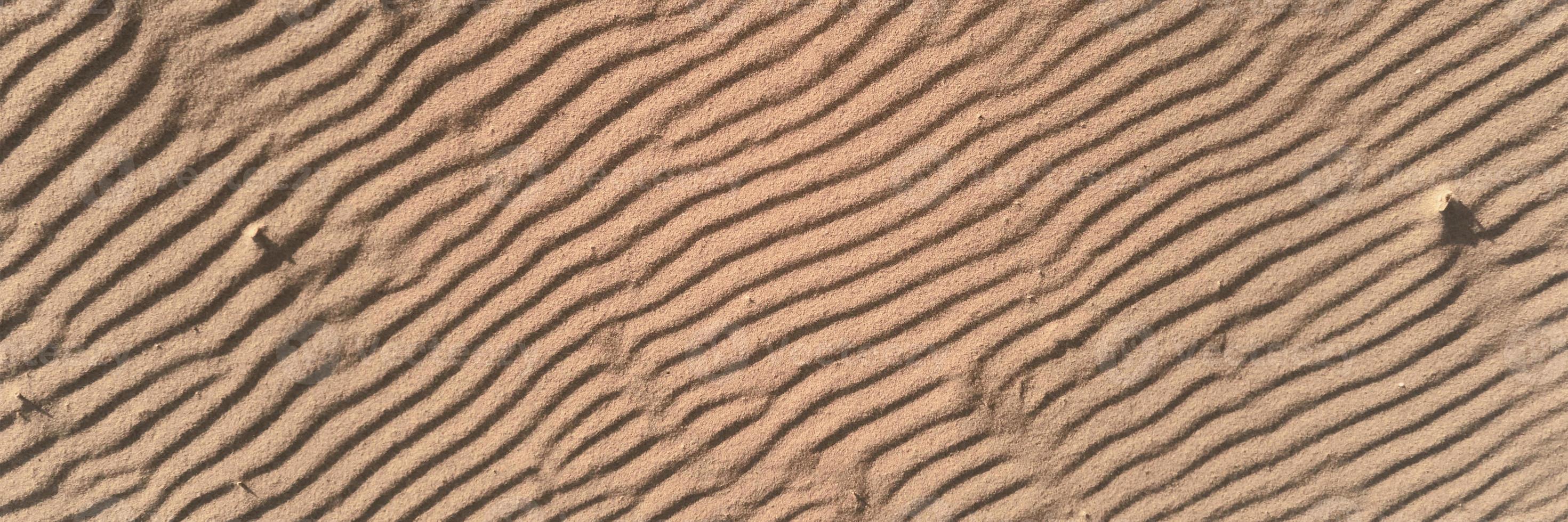 Desert sand texture with line pattern, top view photo