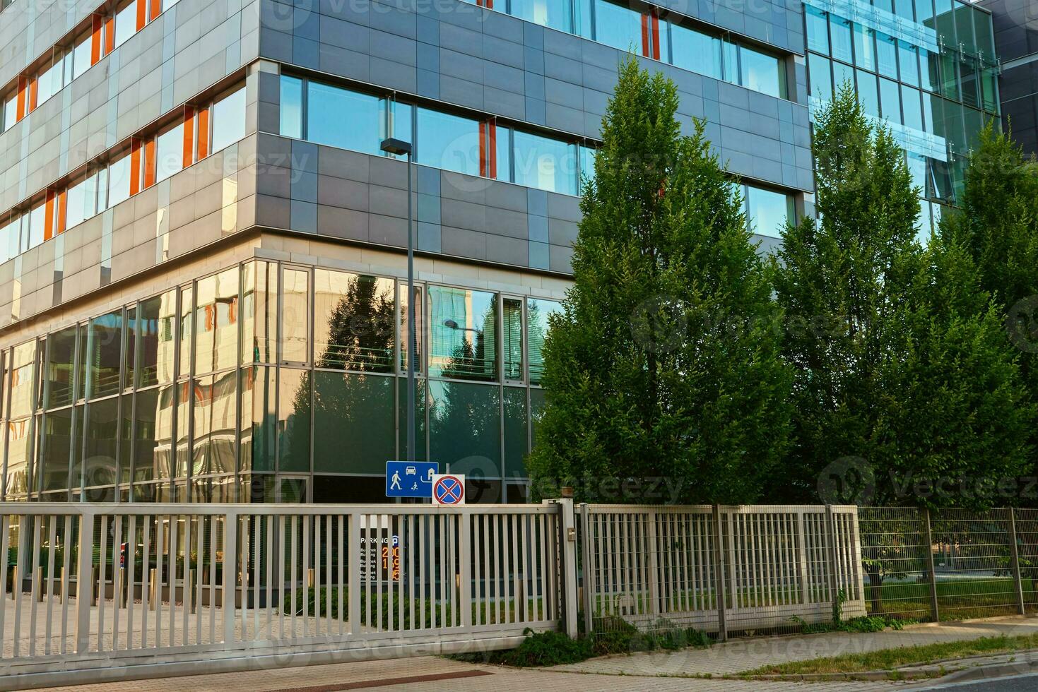 Modern office building with green trees photo