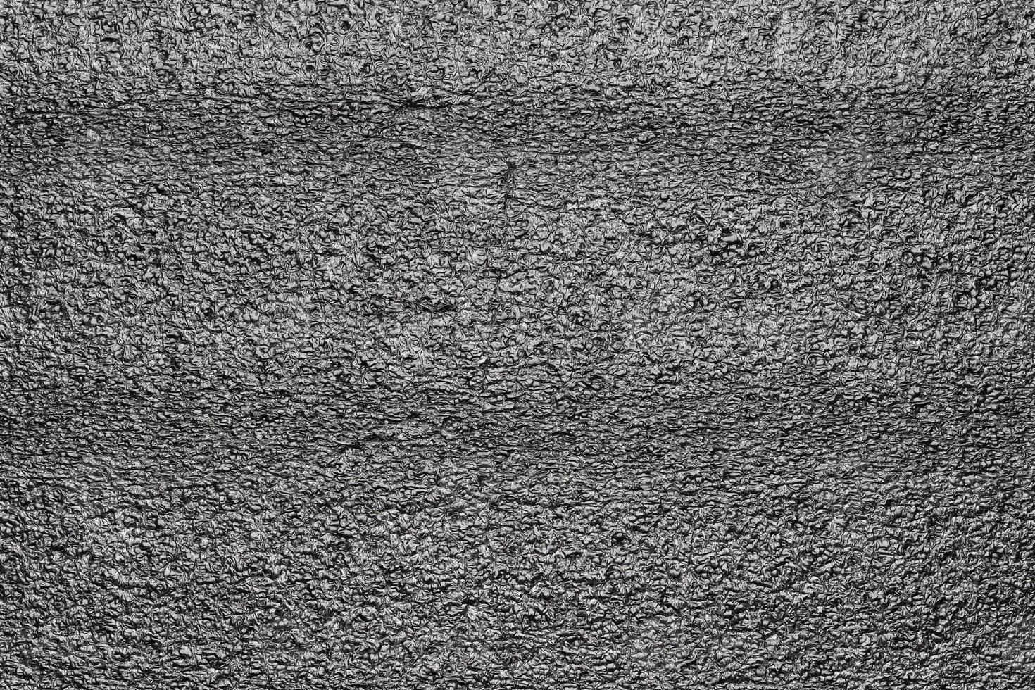 Black abstract polystyrene foam texture background. Close-up styrofoam pattern photo