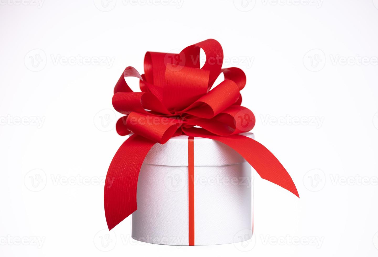 A gift box with a red bow photo