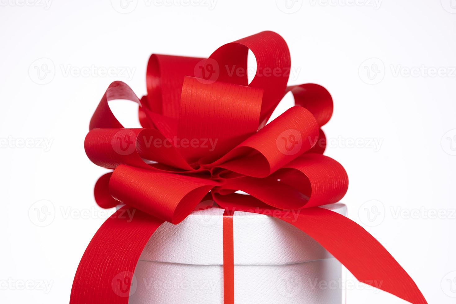 A gift box with a red bow photo