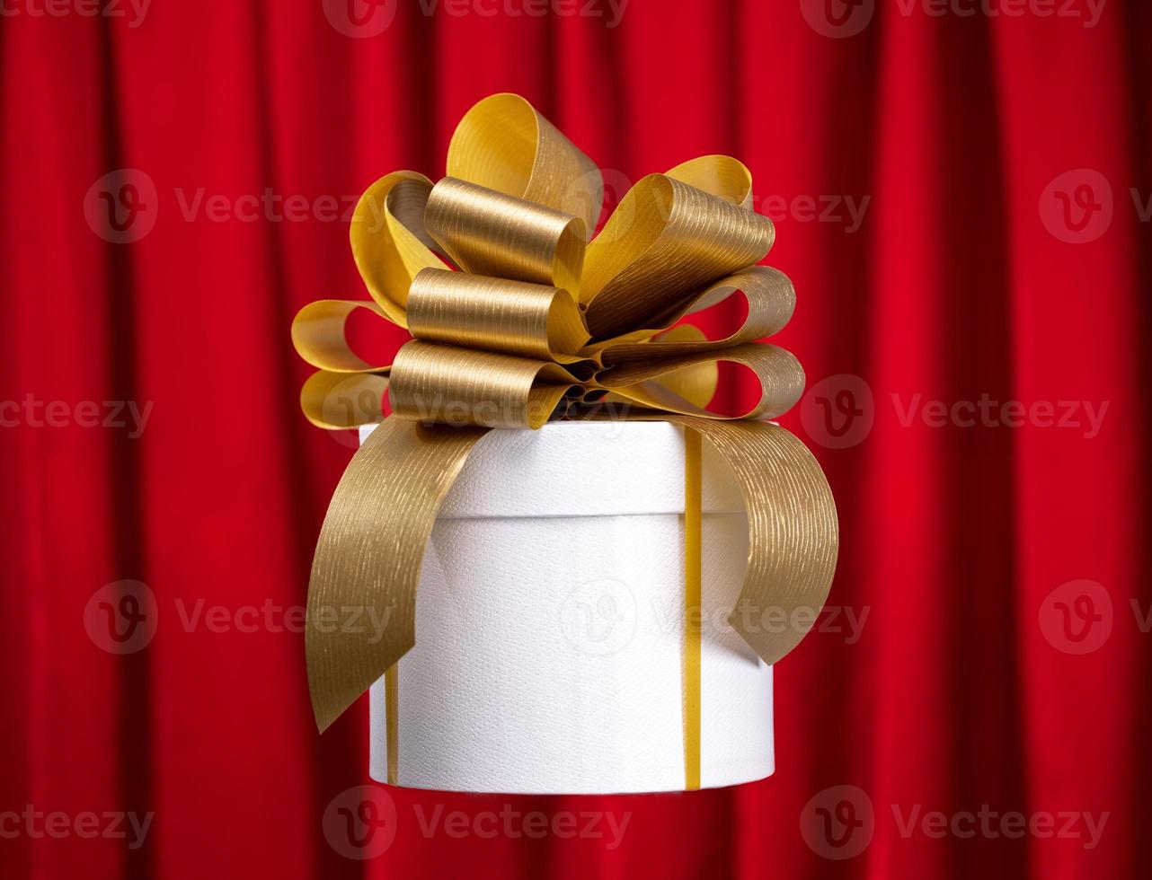 A gift box with a golden bow photo
