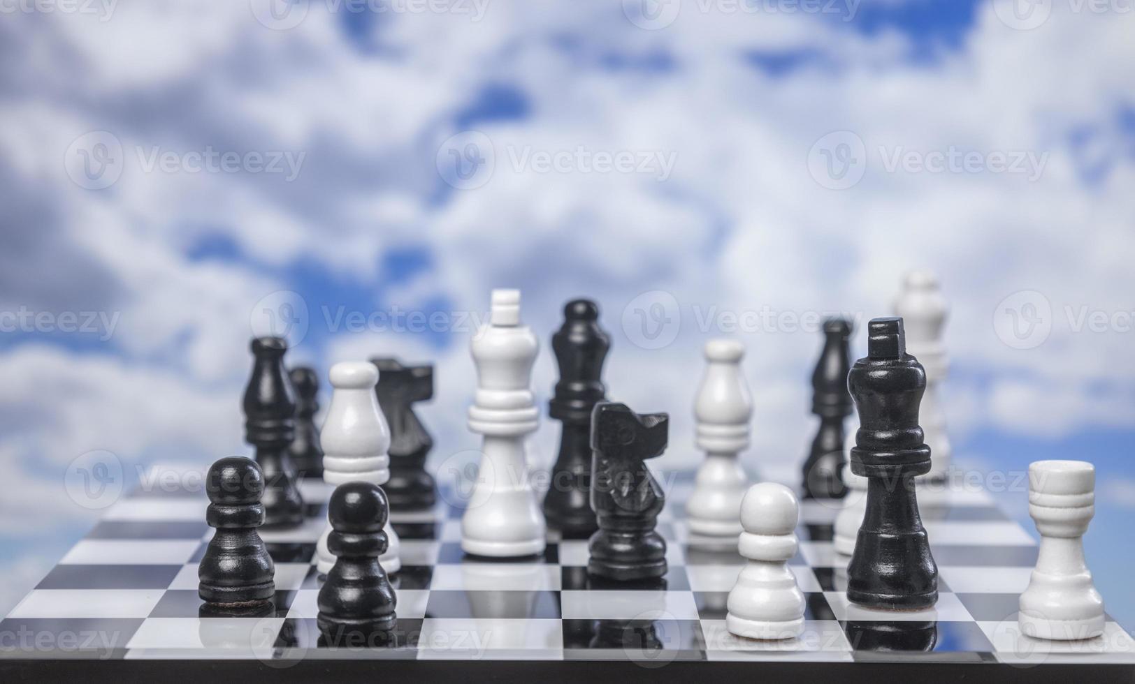 A game of chess with passing clouds behind photo