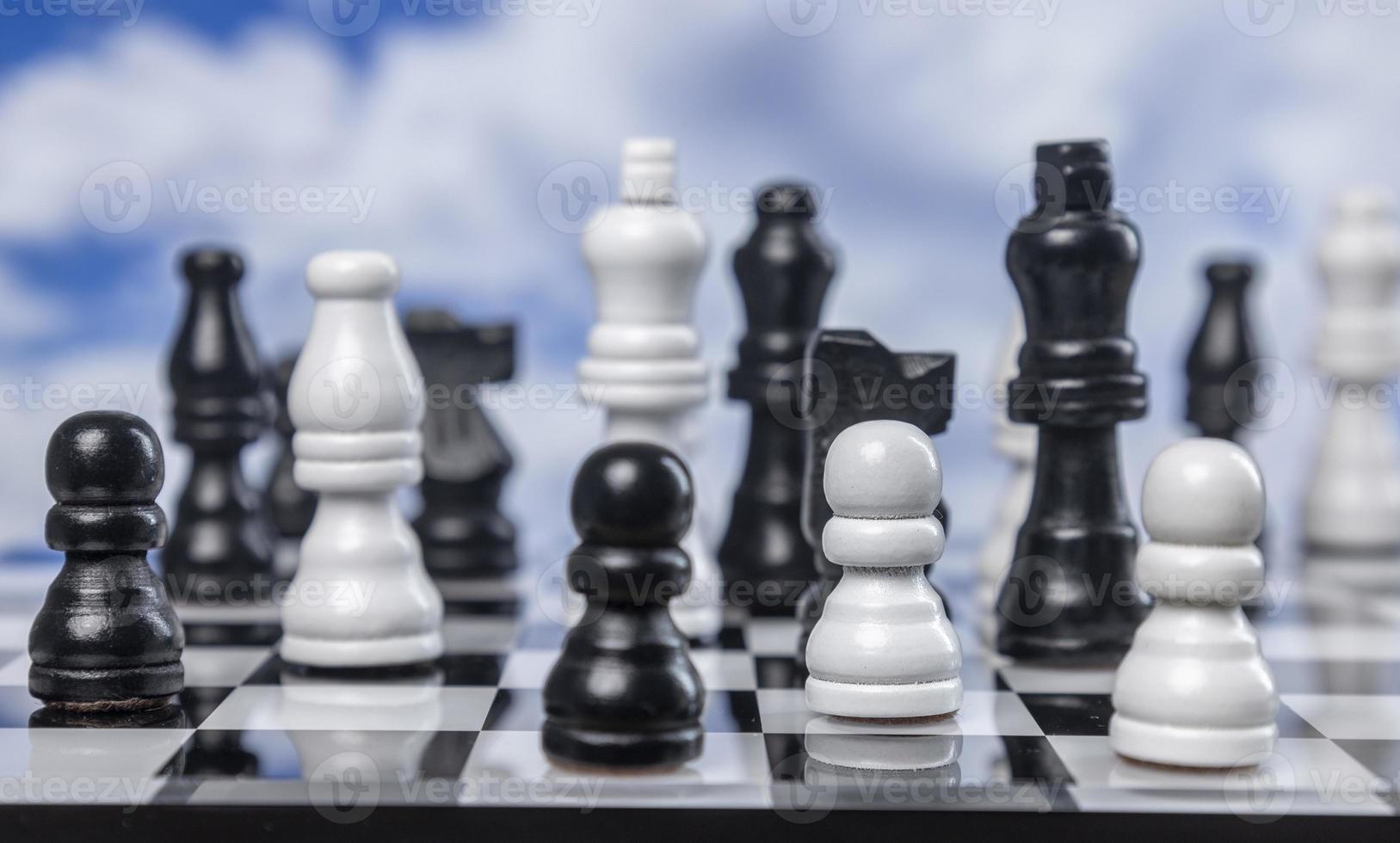 A game of chess with passing clouds behind photo
