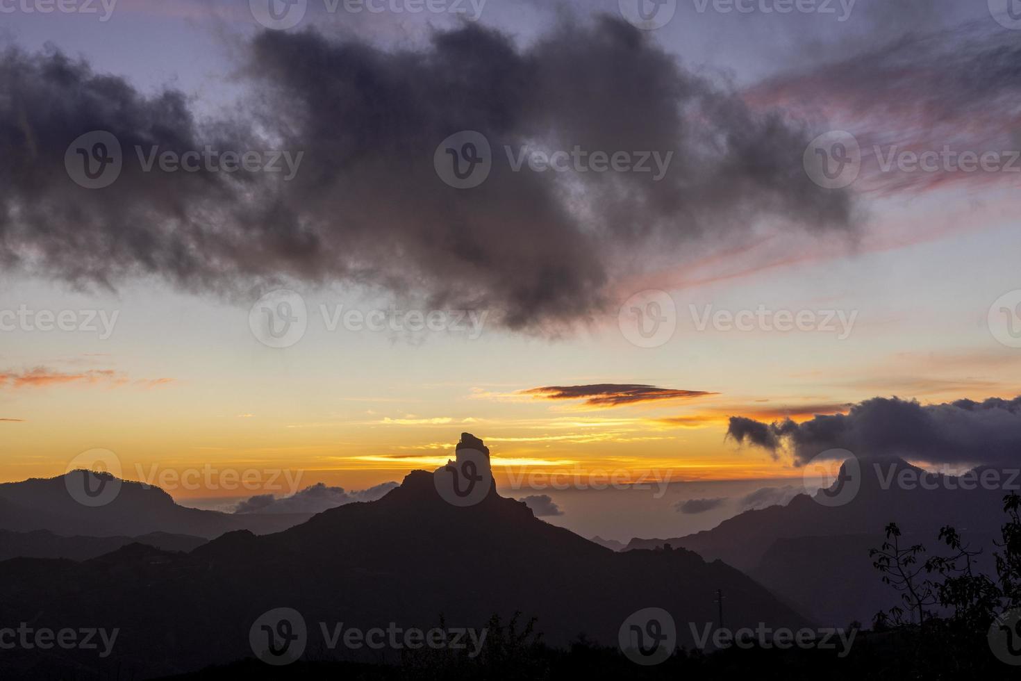 The roque nublo in gran canaria, canary islands during sunset with amazing abstract colours photo