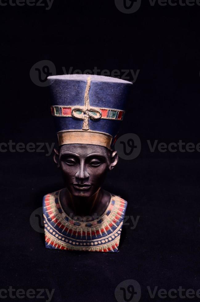 Egyptian statue on dark background photo