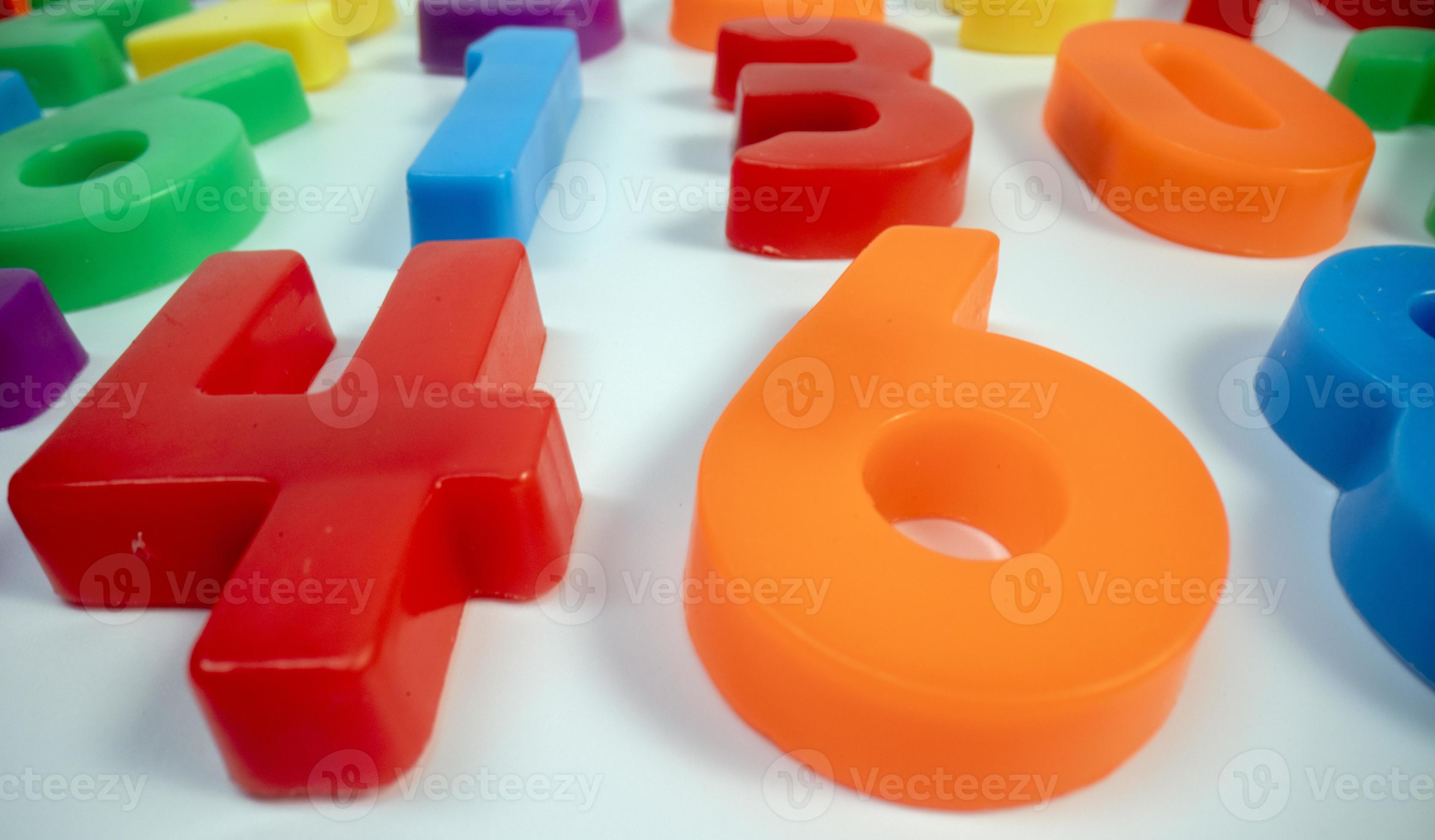 Macro shot of multi coloured numbers on plain white background