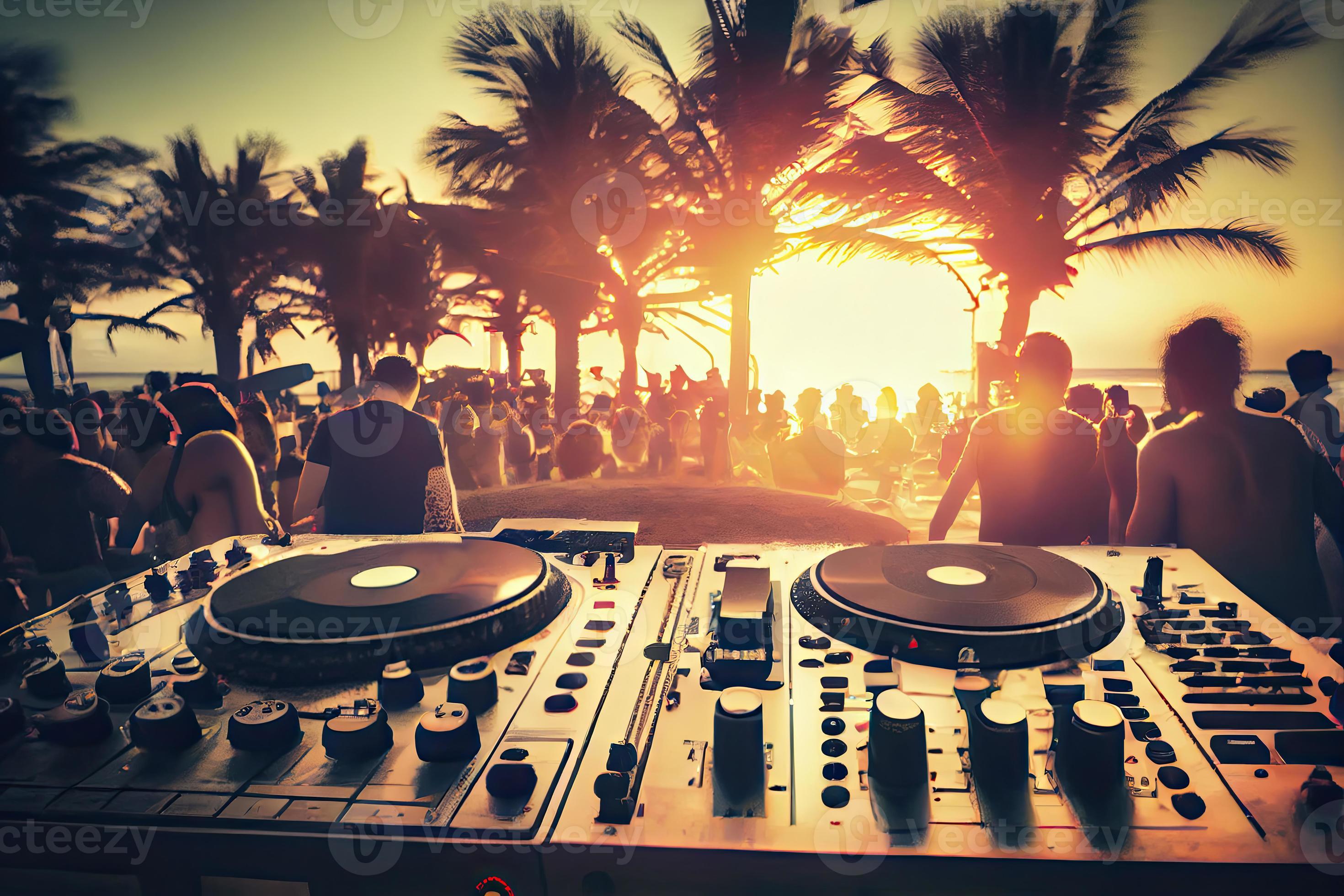 Dj mixing outdoor at beach party festival with crowd of people in