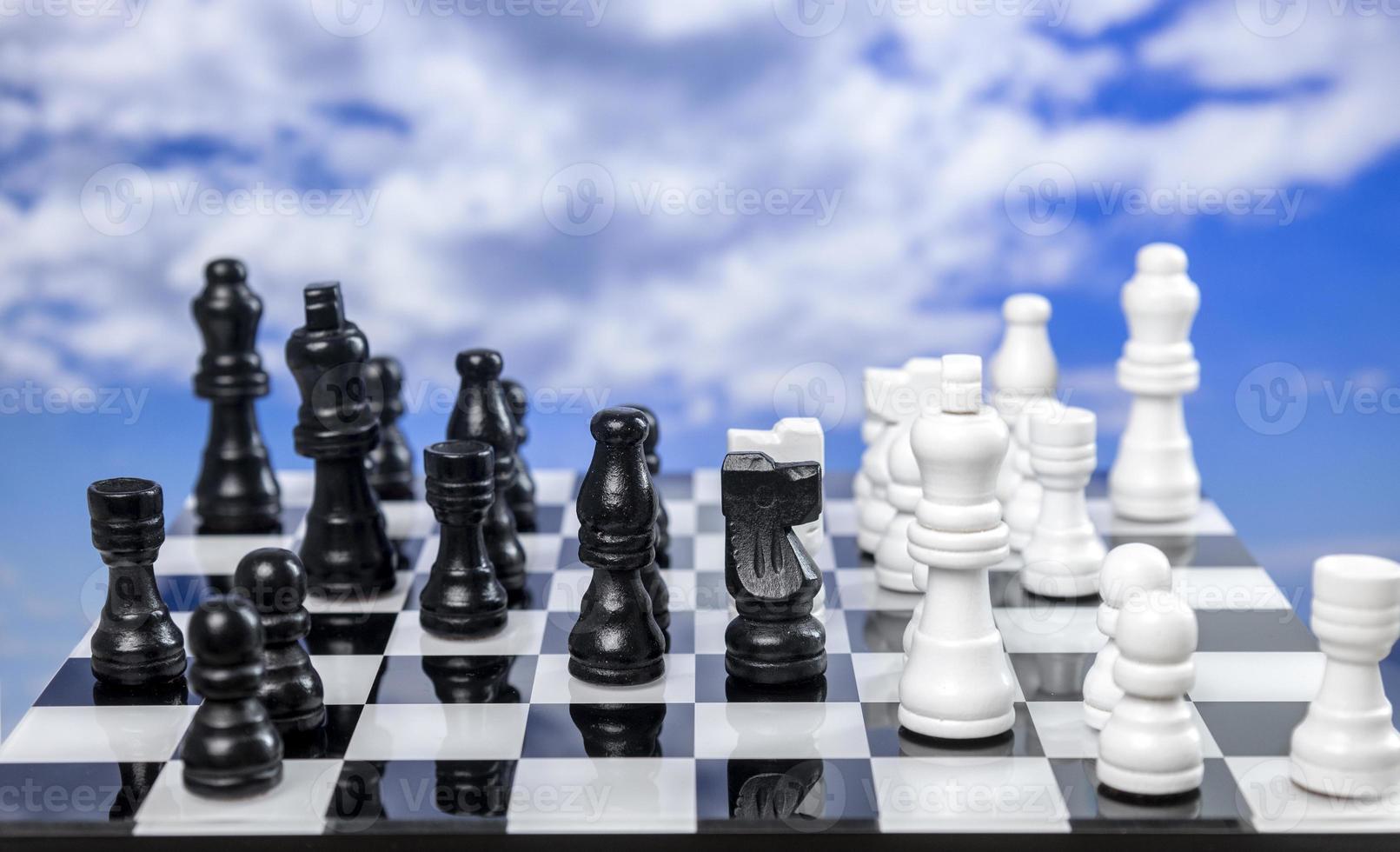A game of chess with passing clouds behind photo