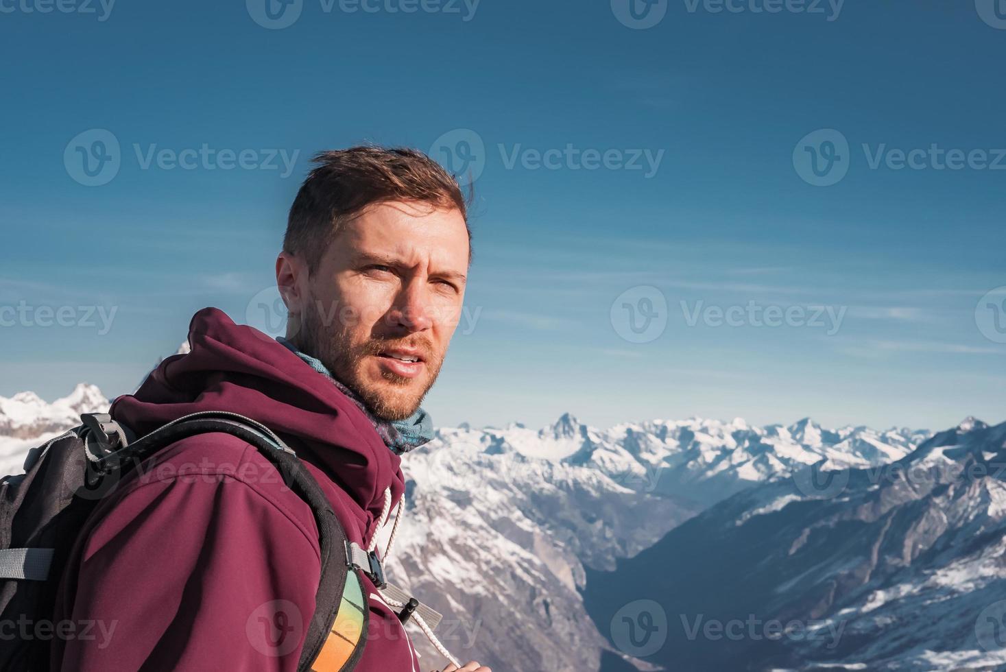 Young man at the peak of the Matterhorn Glacier Paradise. Exploring Swiss Alps from the top of the Glacier. photo