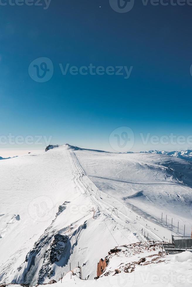 Ski slope and snow covered winter mountains. Matterhorn is a mountain in the Pennine Alps on the border between Switzerland and Italy. Peak of the Matterhorn Glacier Paradise. photo