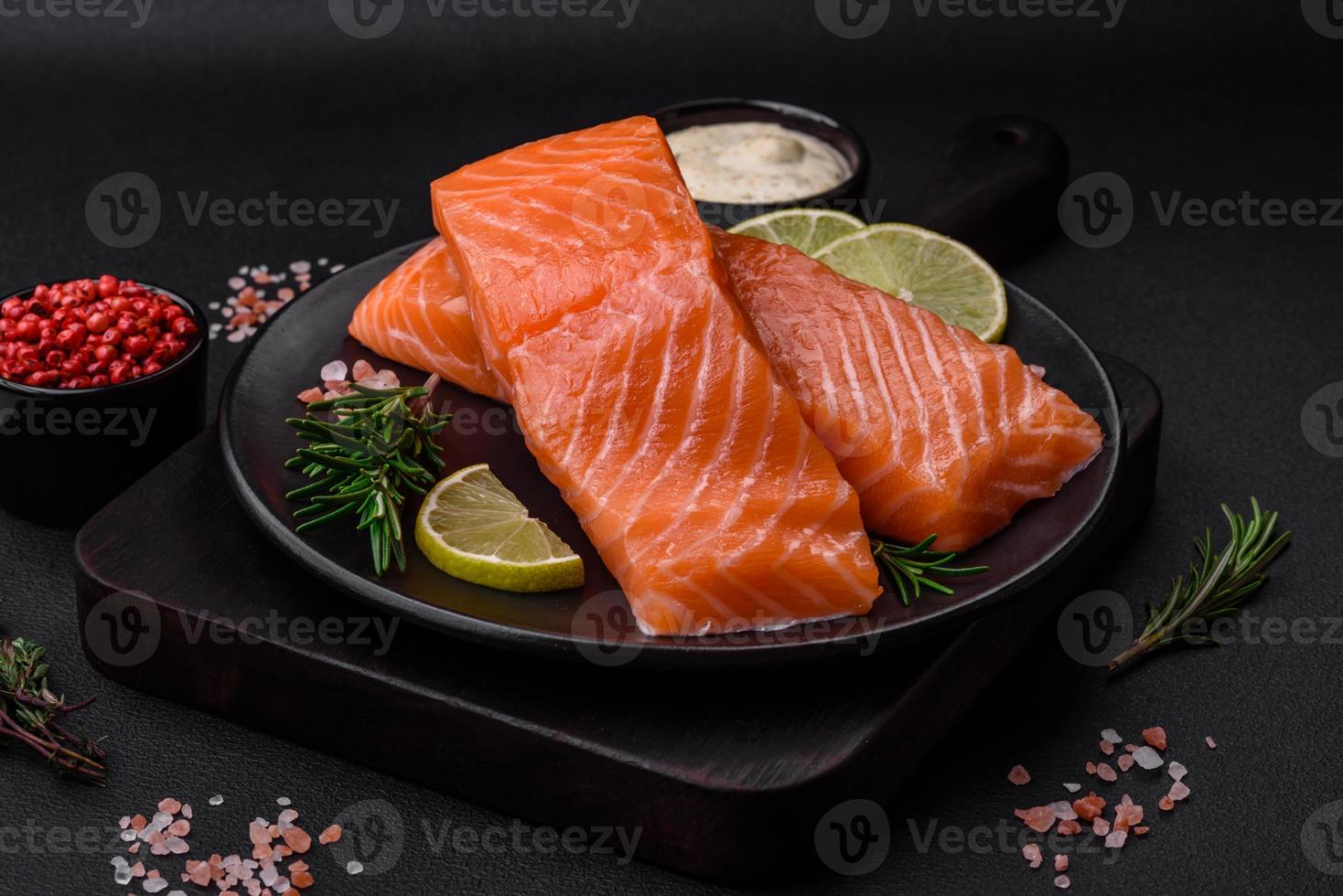 Fresh tasty raw red fish fillet with spices and herbs photo