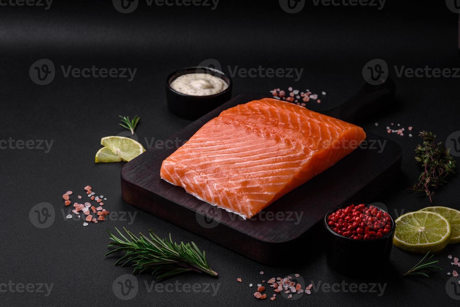 Fresh tasty raw red fish fillet with spices and herbs photo