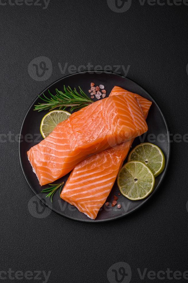 Fresh tasty raw red fish fillet with spices and herbs photo