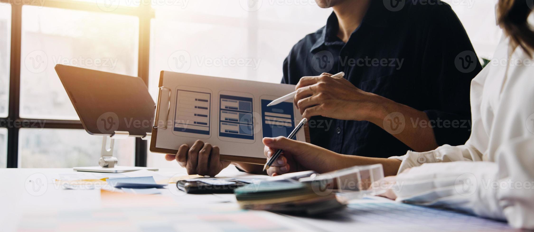 Close up ux developer and ui designer use augmented reality brainstorming about mobile app interface wireframe design on desk at modern office.Creative digital development agency photo