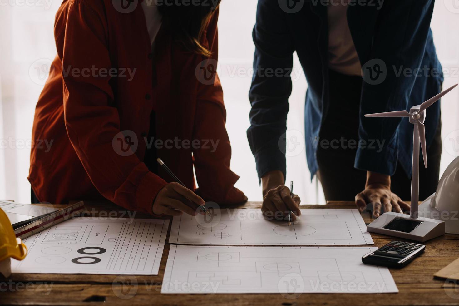 Construction and structure concept of engineer working drawing on blueprint meeting for project working with partner on model building and engineering tools in working site, construction concept photo
