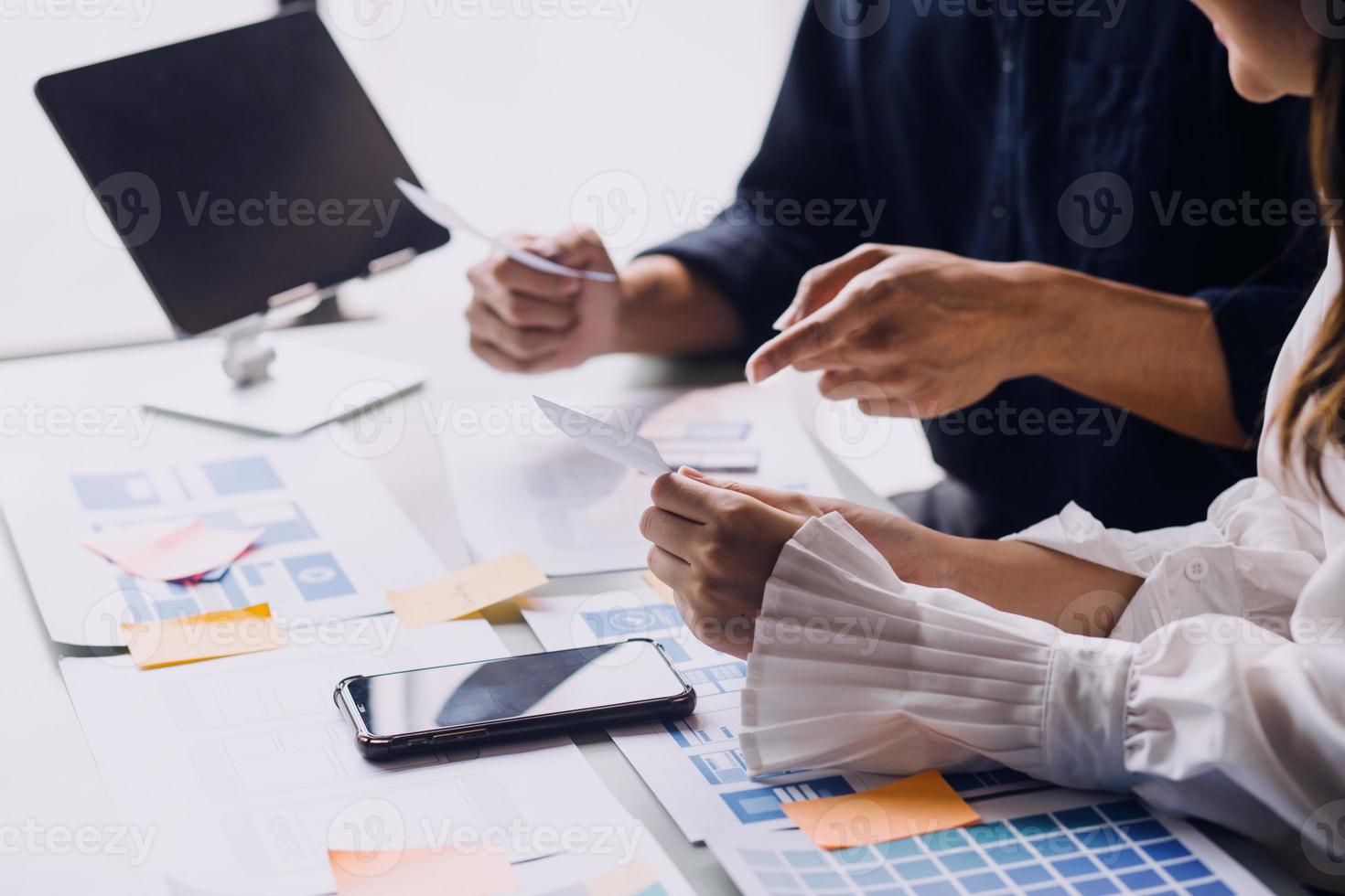 Close up ux developer and ui designer use augmented reality brainstorming about mobile app interface wireframe design on desk at modern office.Creative digital development agency photo