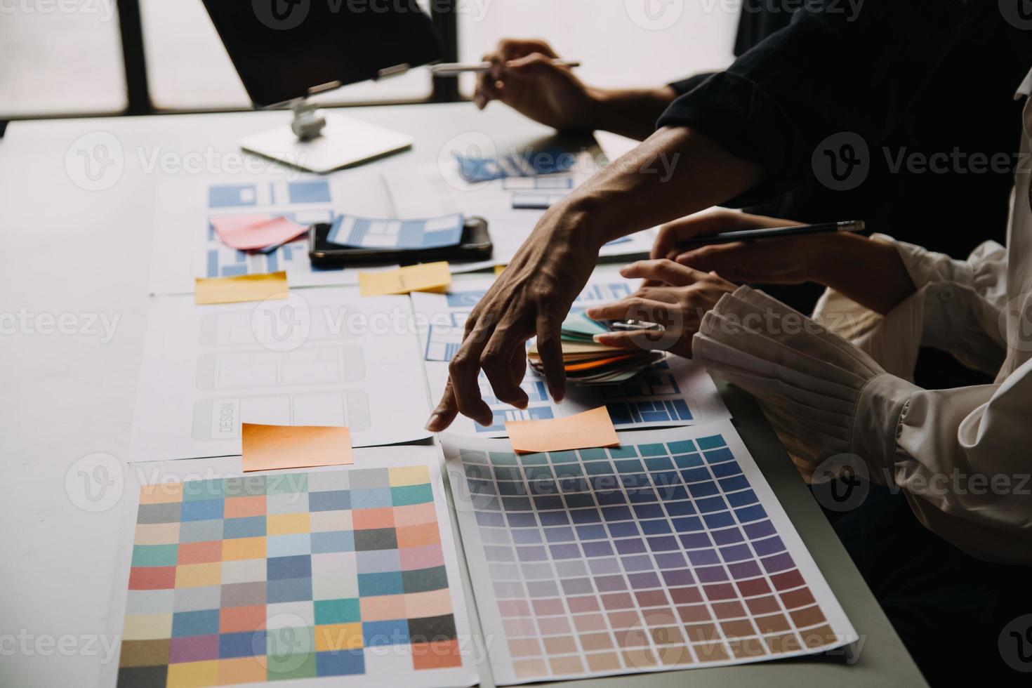 Close up ux developer and ui designer use augmented reality brainstorming about mobile app interface wireframe design on desk at modern office.Creative digital development agency photo