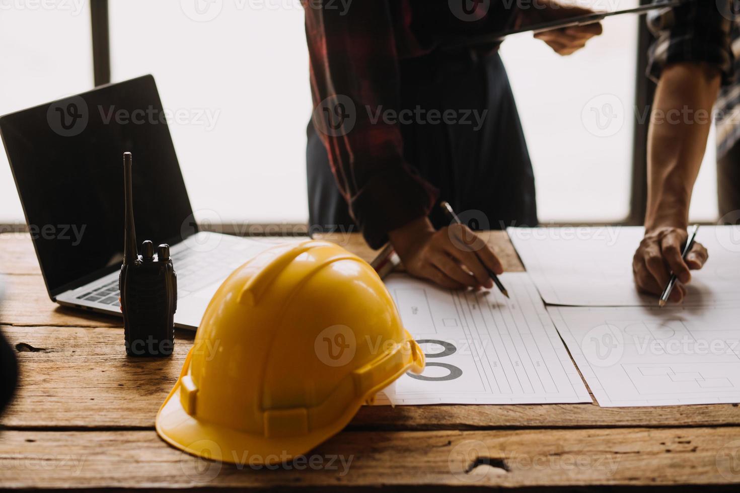 Construction and structure concept of engineer working drawing on blueprint meeting for project working with partner on model building and engineering tools in working site, construction concept photo