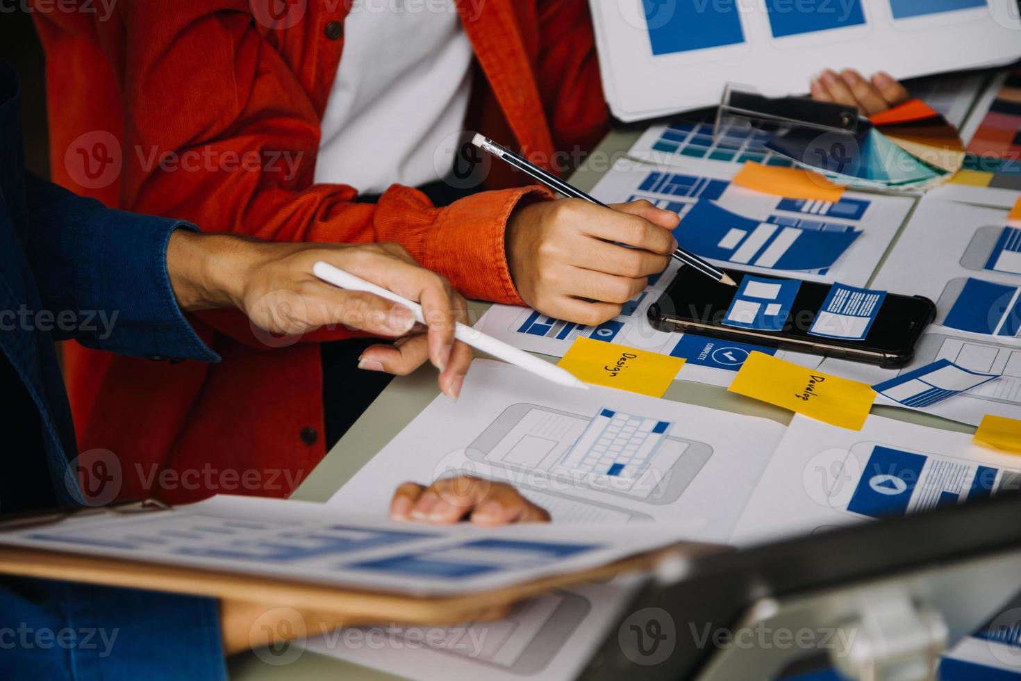 Close up ux developer and ui designer use augmented reality brainstorming about mobile app interface wireframe design on desk at modern office.Creative digital development agency photo