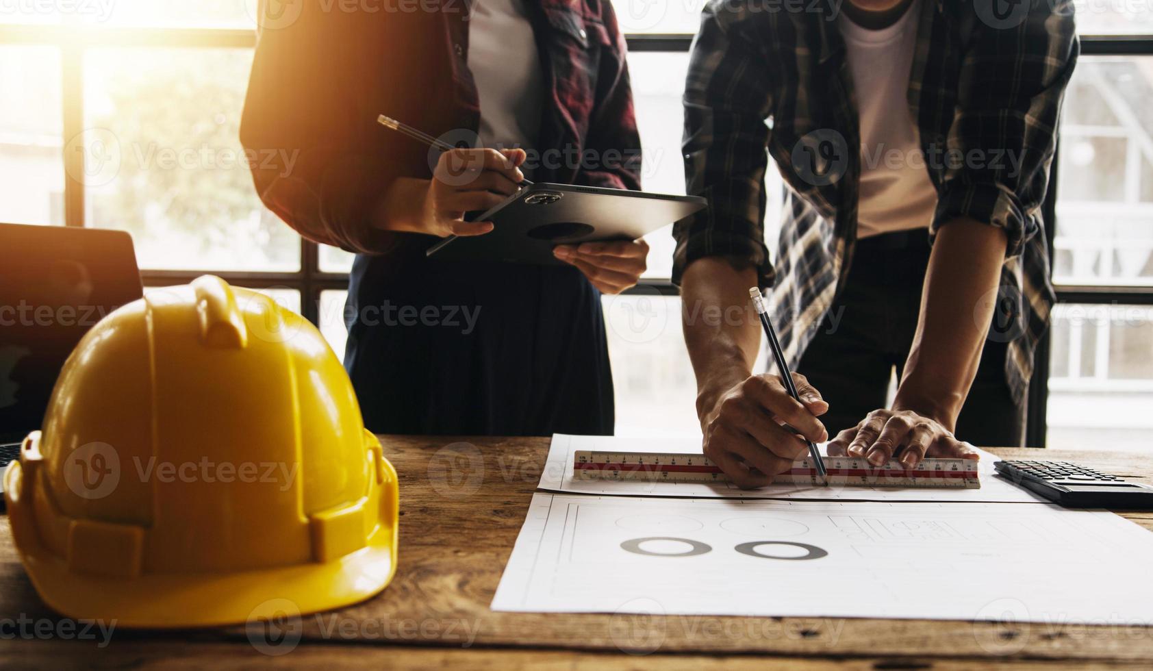 Construction and structure concept of engineer working drawing on blueprint meeting for project working with partner on model building and engineering tools in working site, construction concept photo