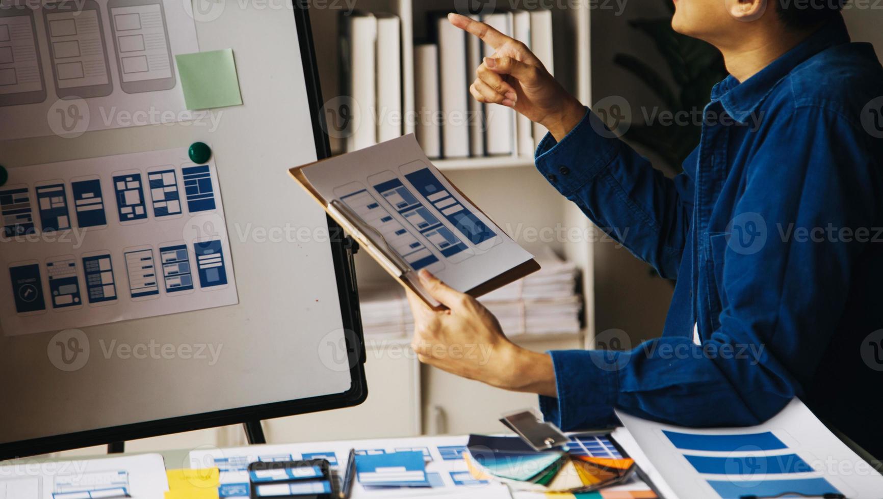 Close up ux developer and ui designer use augmented reality brainstorming about mobile app interface wireframe design on desk at modern office.Creative digital development agency photo