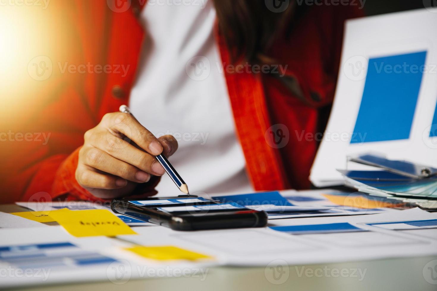 Close up ux developer and ui designer use augmented reality brainstorming about mobile app interface wireframe design on desk at modern office.Creative digital development agency photo