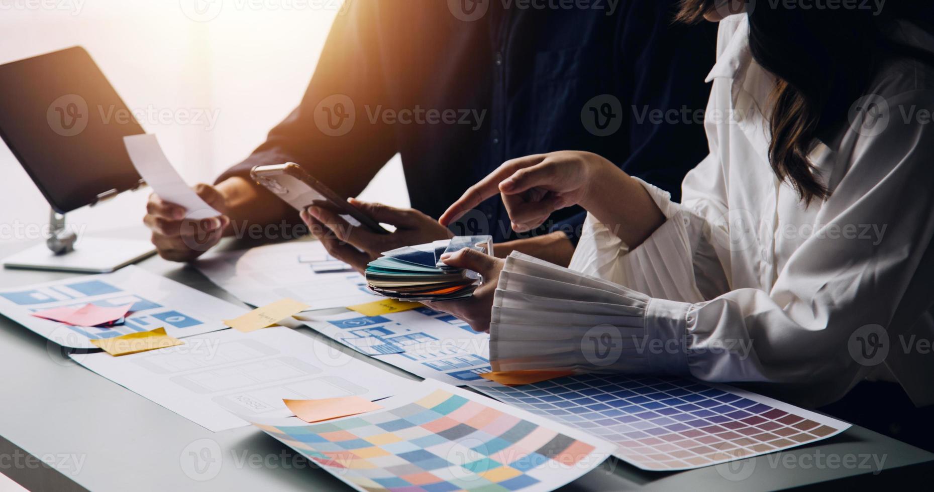 Close up ux developer and ui designer use augmented reality brainstorming about mobile app interface wireframe design on desk at modern office.Creative digital development agency photo