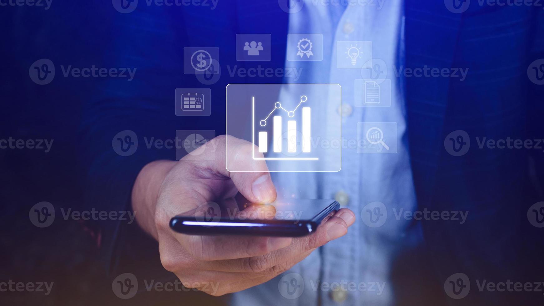 Data analytics and business intelligence BI concept with chart and graph icons on digital screen interface on smartphone and business people in the background. photo