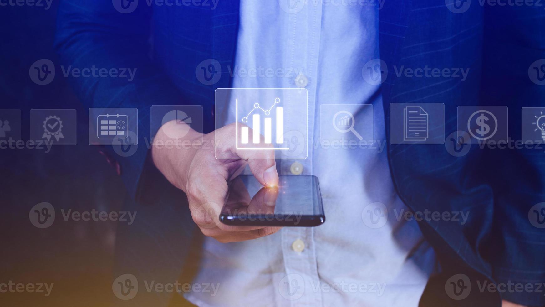 Data analytics and business intelligence BI concept with chart and graph icons on digital screen interface on smartphone and business people in the background. photo
