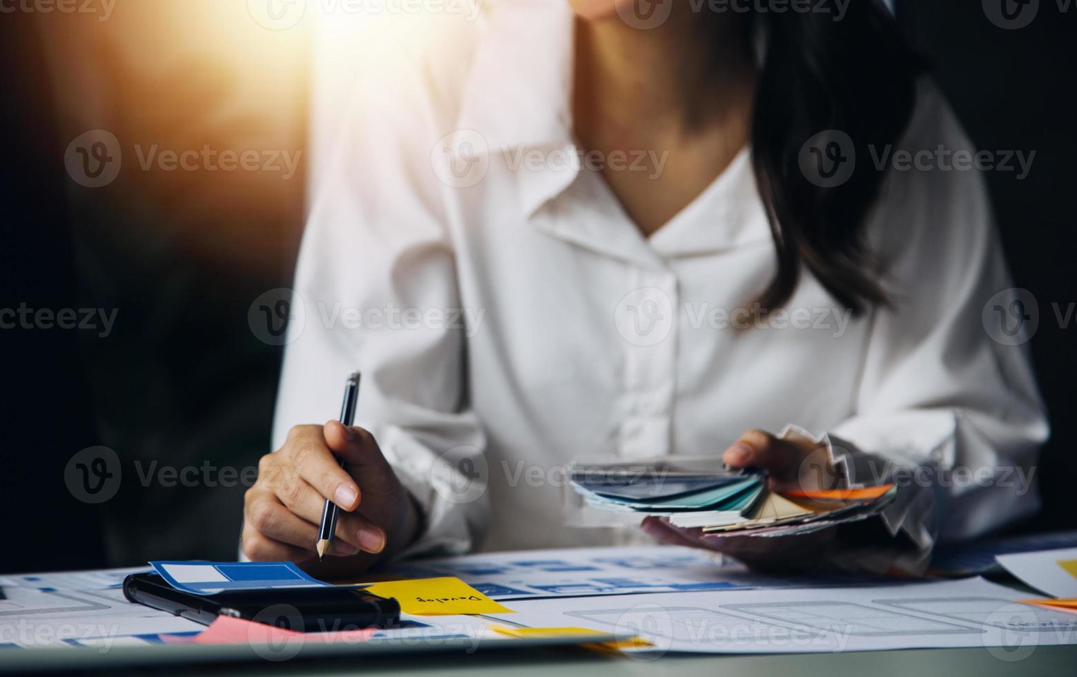 Close up ux developer and ui designer use augmented reality brainstorming about mobile app interface wireframe design on desk at modern office.Creative digital development agency photo