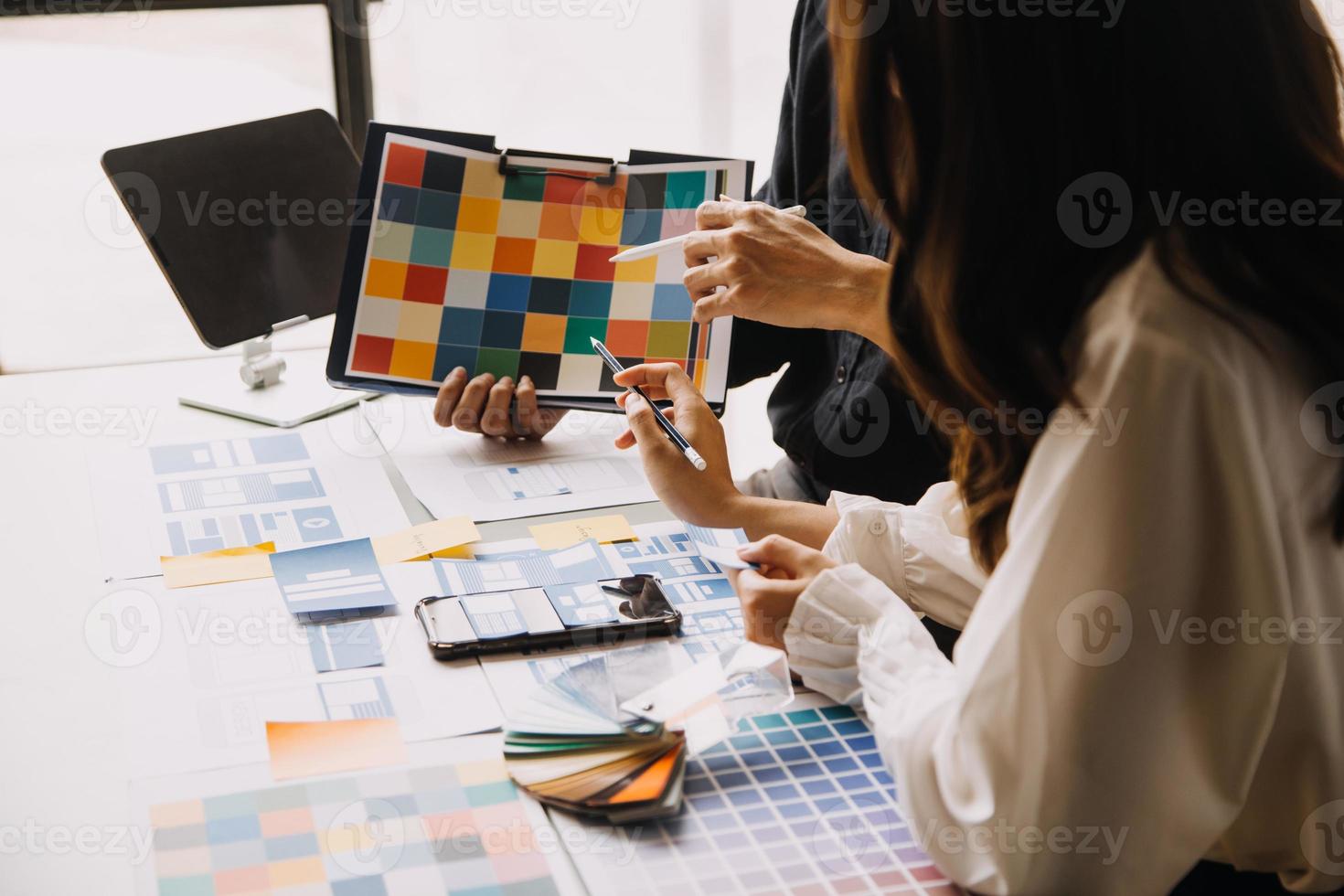 Close up ux developer and ui designer use augmented reality brainstorming about mobile app interface wireframe design on desk at modern office.Creative digital development agency photo