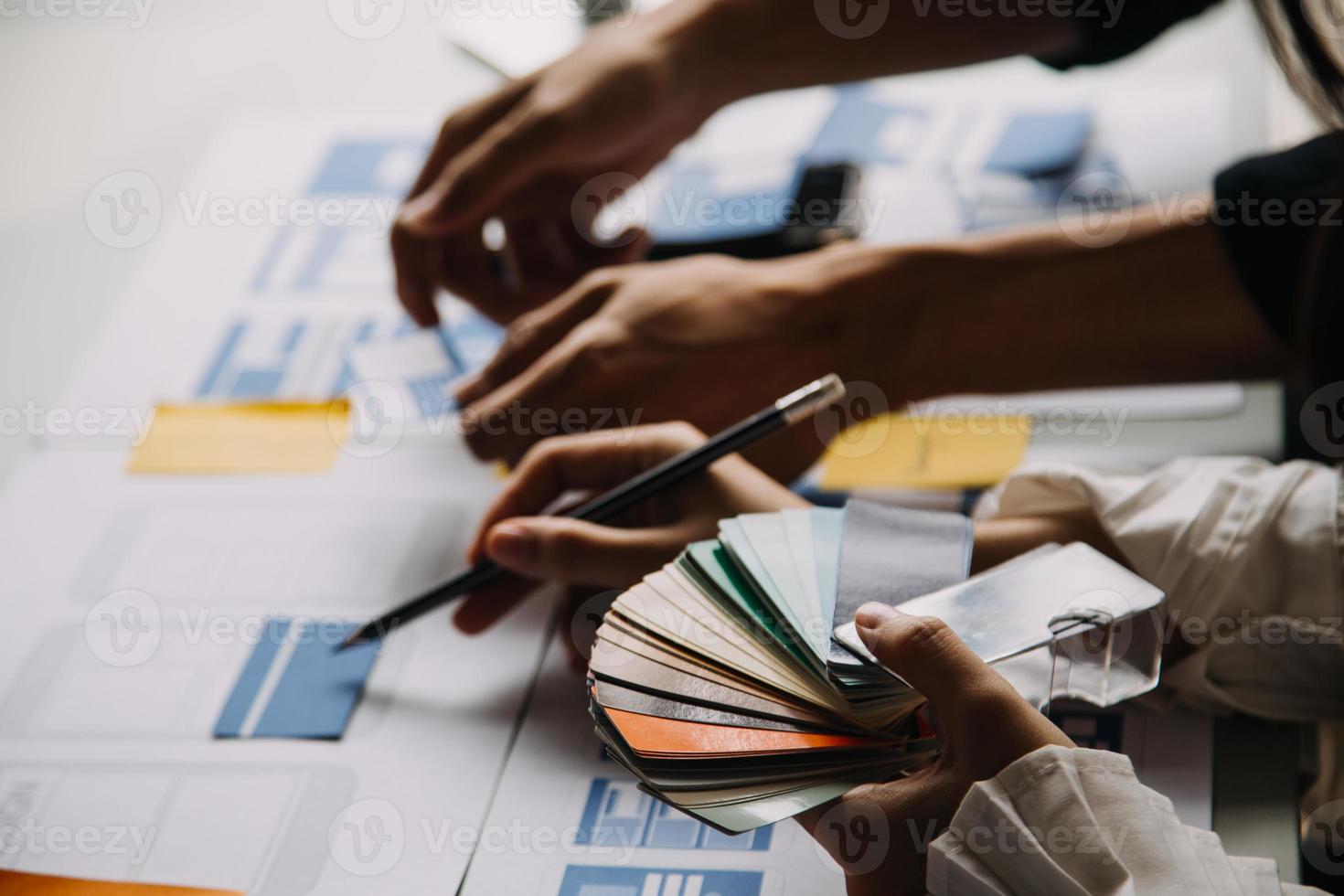Close up ux developer and ui designer use augmented reality brainstorming about mobile app interface wireframe design on desk at modern office.Creative digital development agency photo