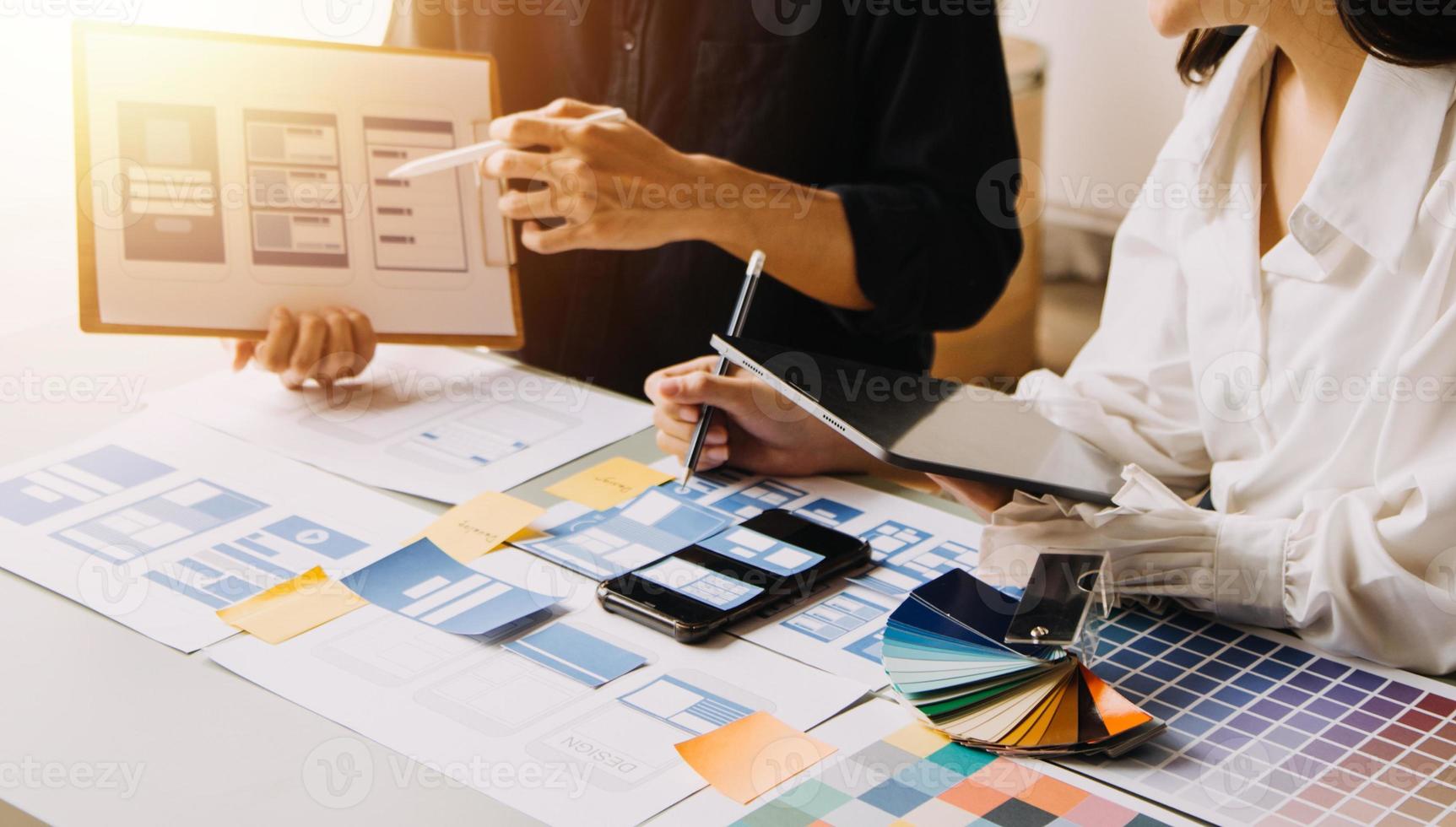 Close up ux developer and ui designer use augmented reality brainstorming about mobile app interface wireframe design on desk at modern office.Creative digital development agency photo