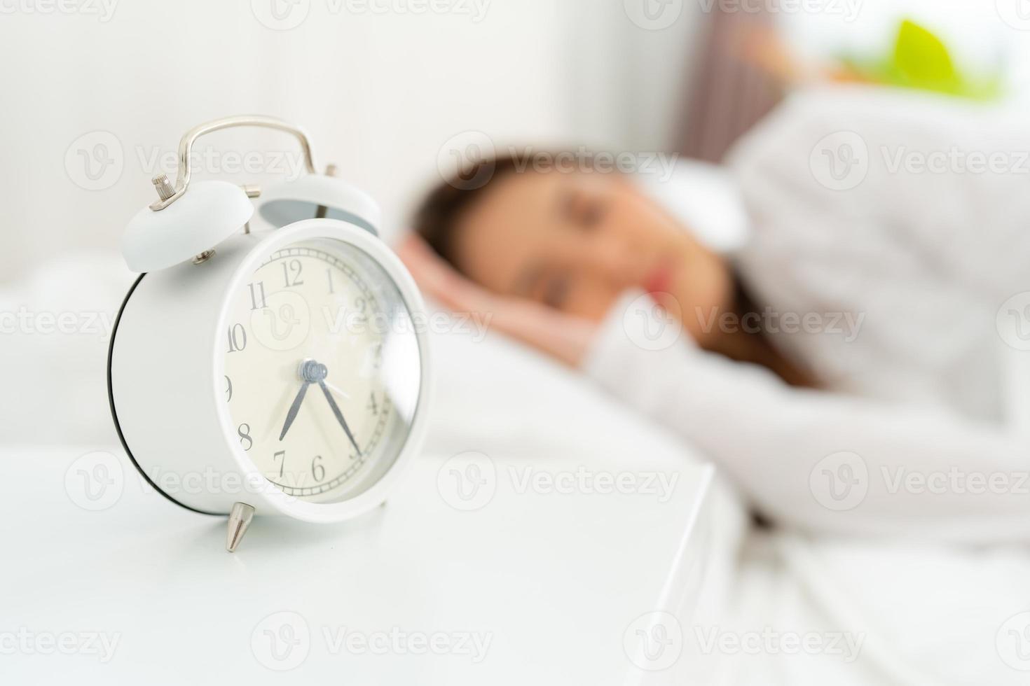 Alarm clock with good day against background happy young woman. photo