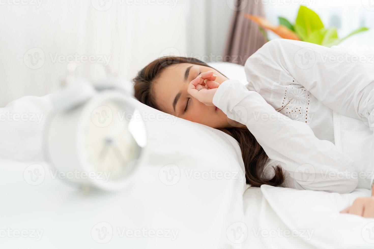 Alarm clock with good day against background happy young woman. photo