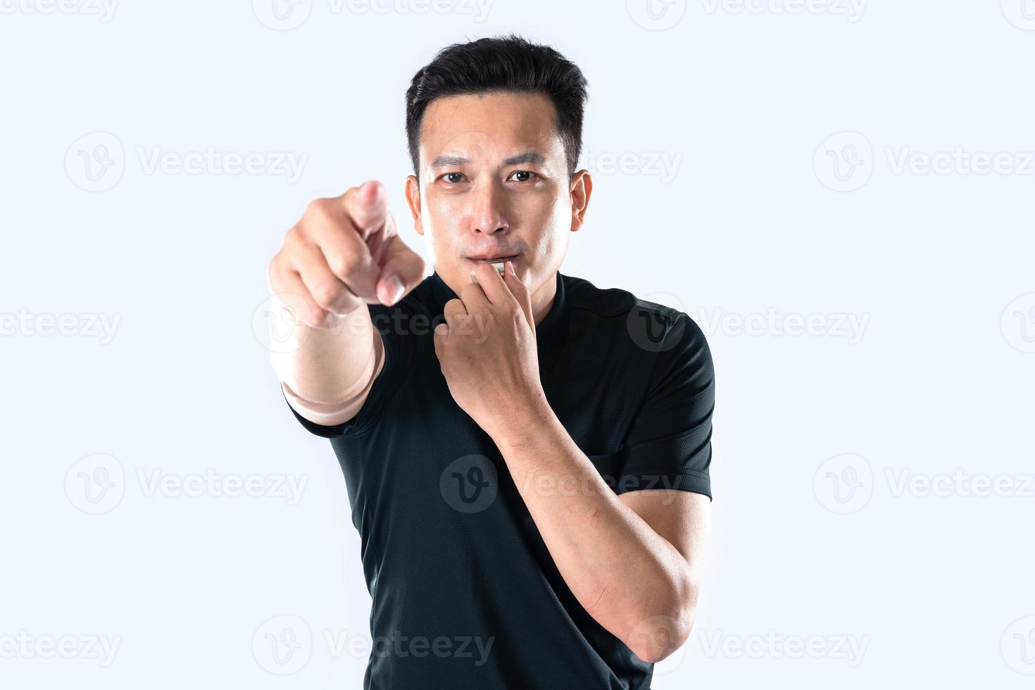 Football referee holding whistle and pointing with isolated hand. photo
