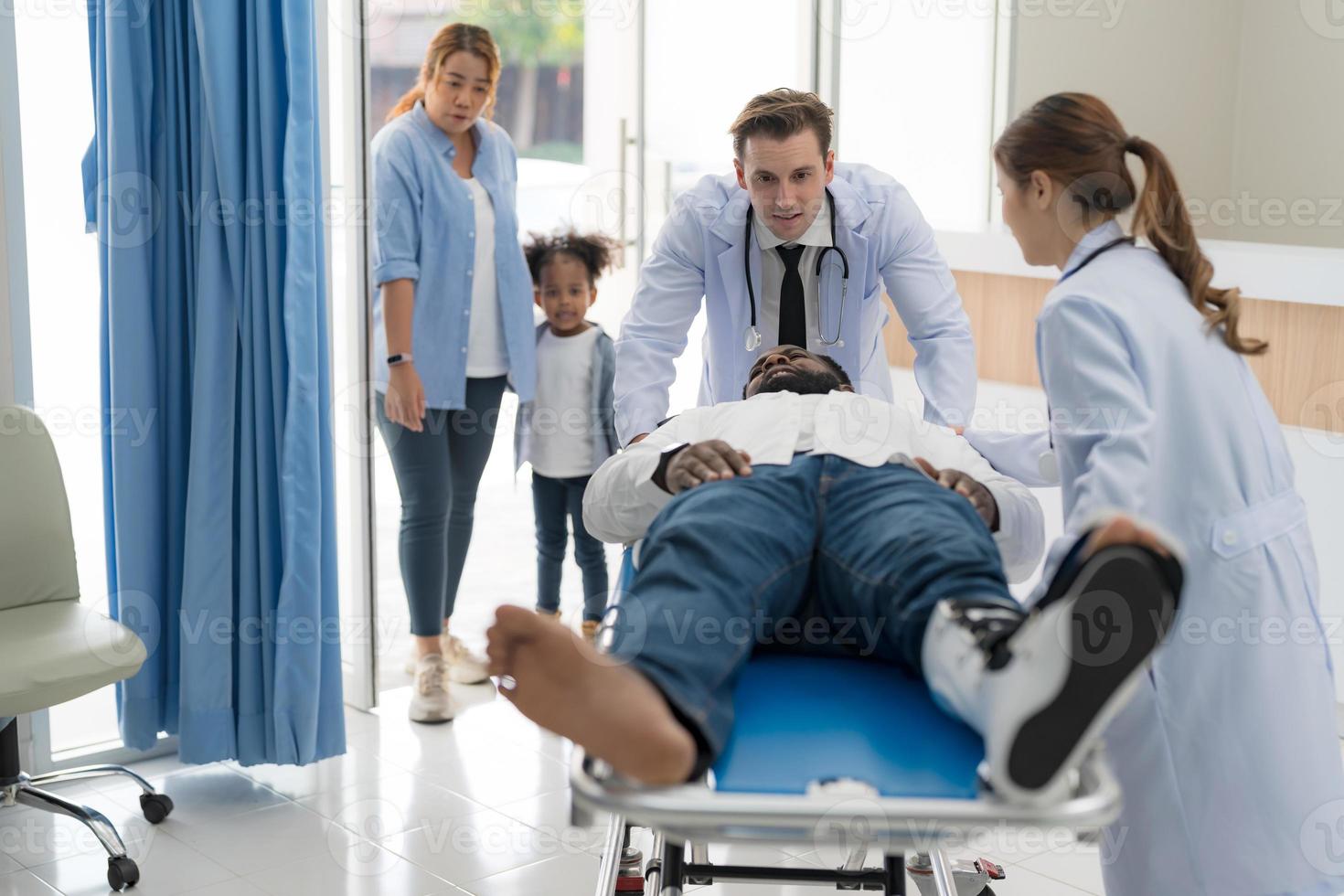 The doctor puts a splint on a patient with a leg. photo