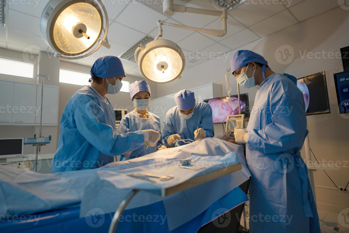 Doctor, nurse doing surgery on patient. photo