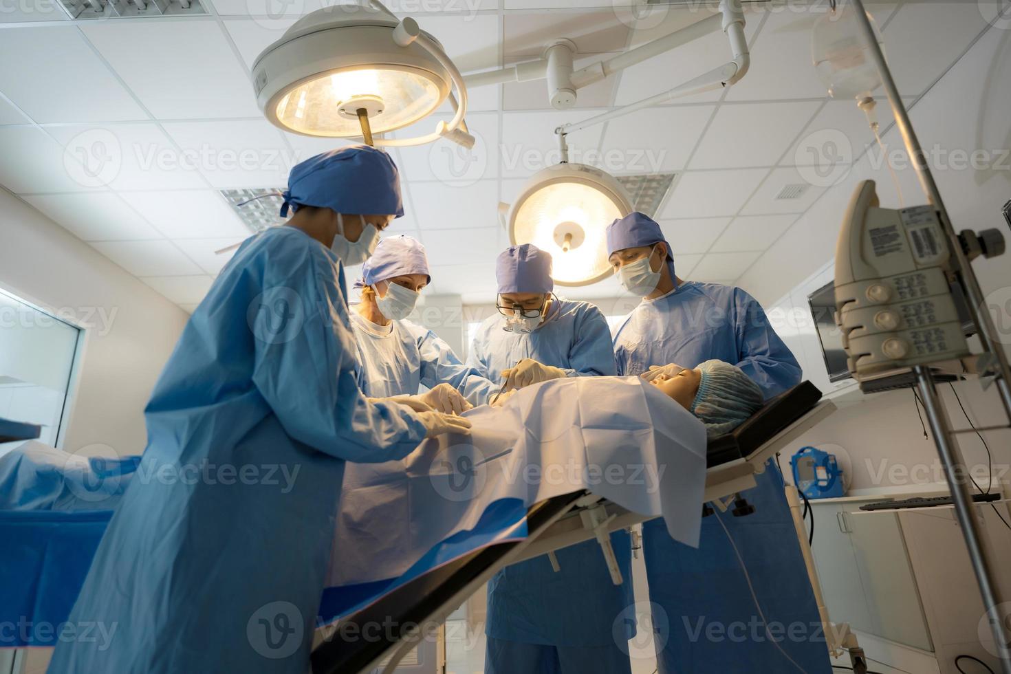 Doctor, nurse doing surgery on patient. photo