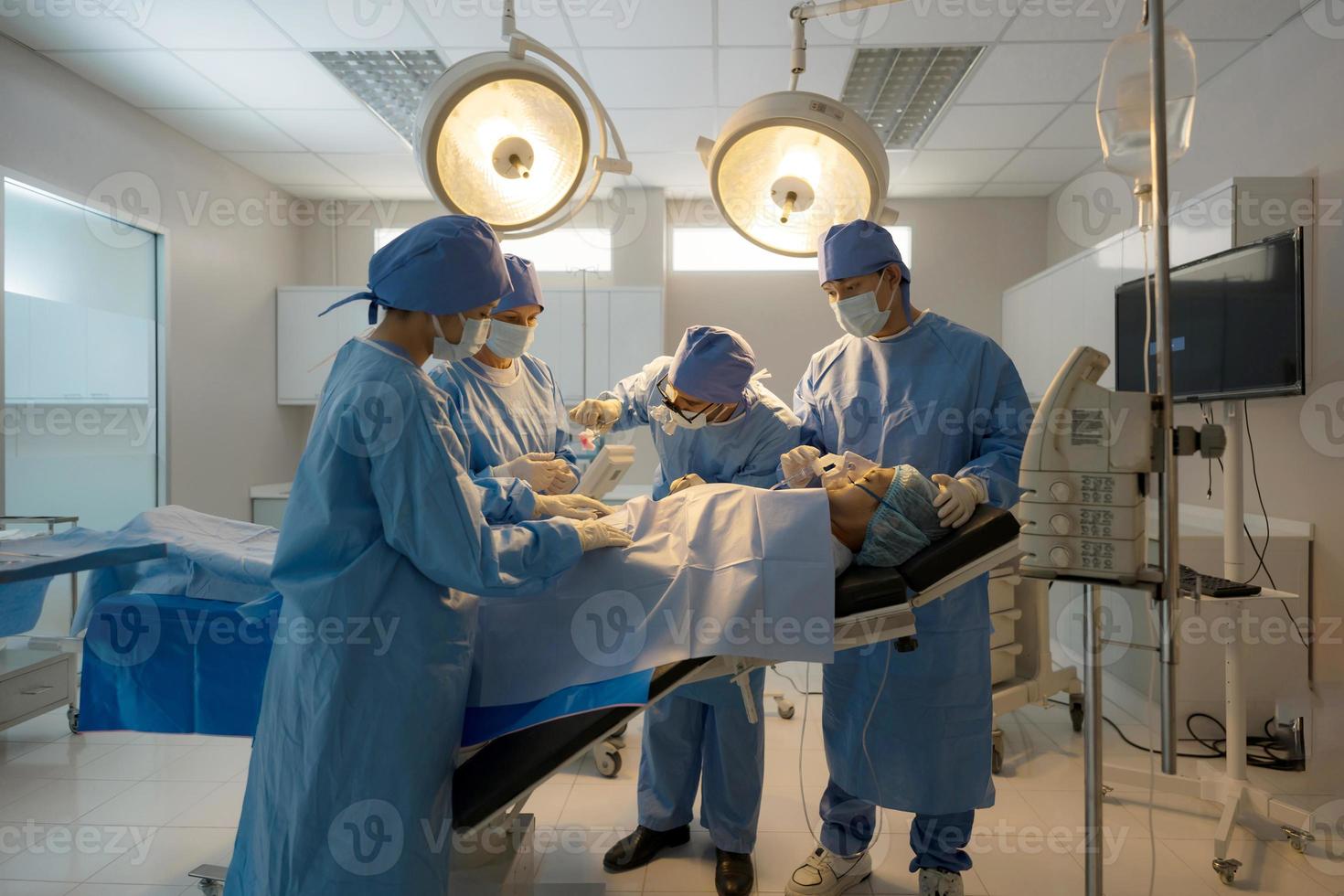 Doctor, nurse doing surgery on patient. photo