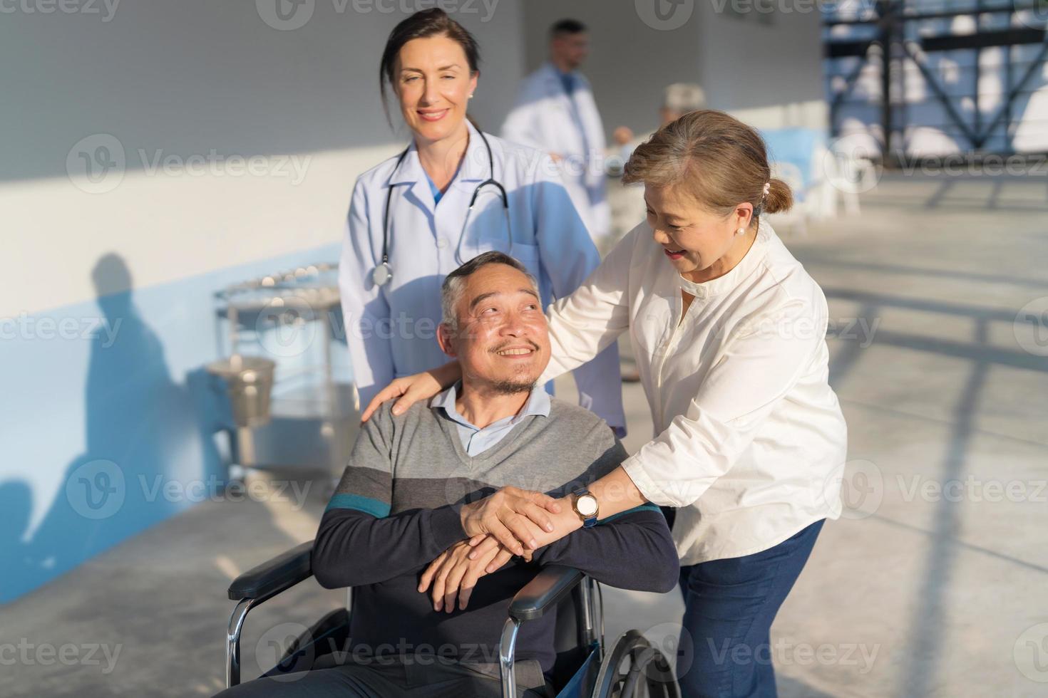 Doctor pushing a wheelchair. photo