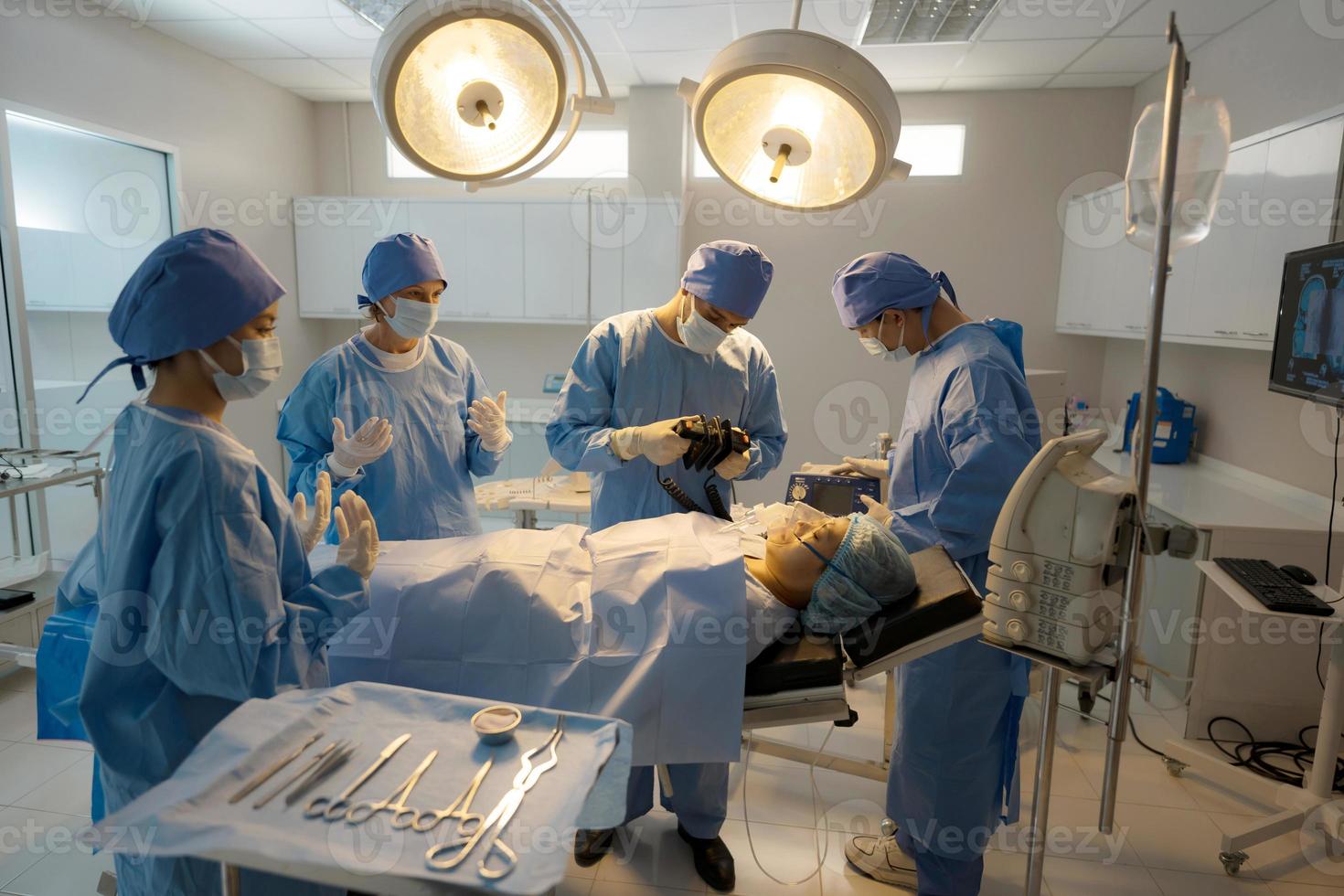 Doctor, nurse doing surgery on patient. photo