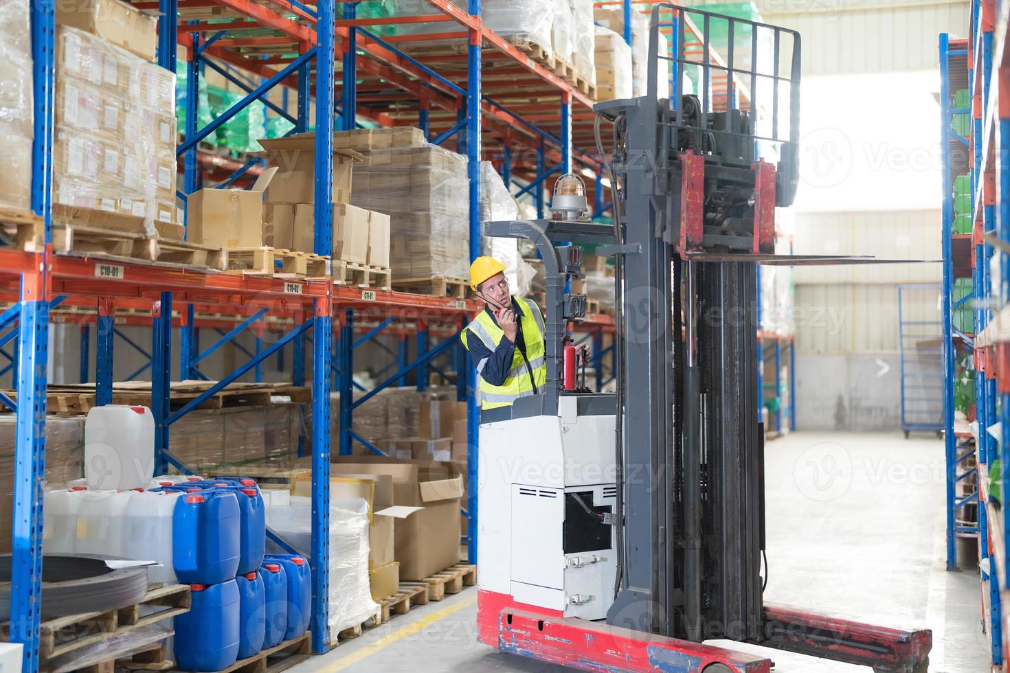 Male employee using a radio in the warehouse. photo