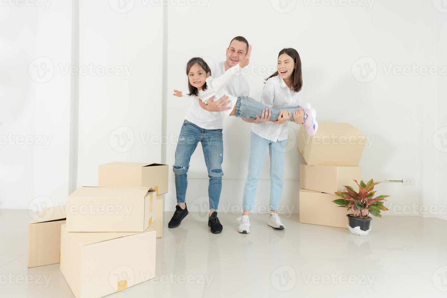 Happy family with girl moving into a new home. photo